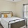 a bedroom with a fan and a bed