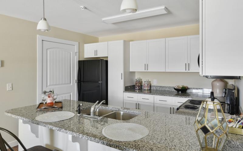 a kitchen with white cabinets