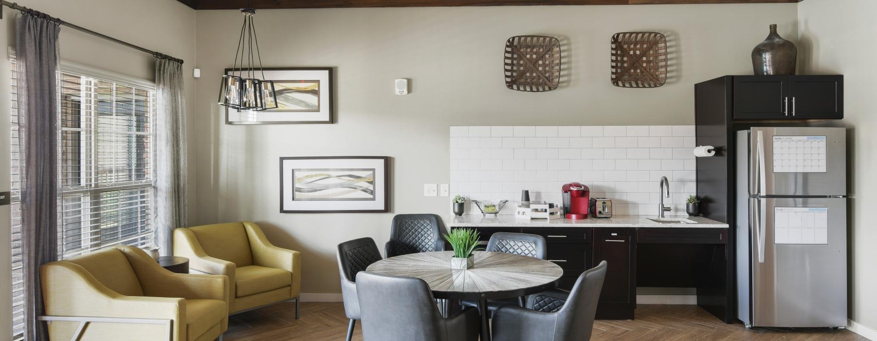 a living room with a table and chairs