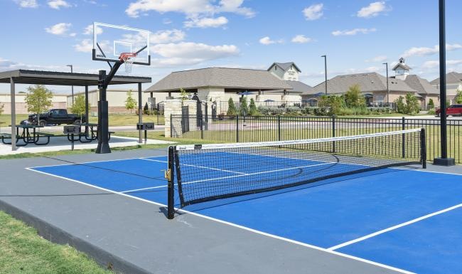 Settle into comfort at Icon Apartments a tennis court with a net